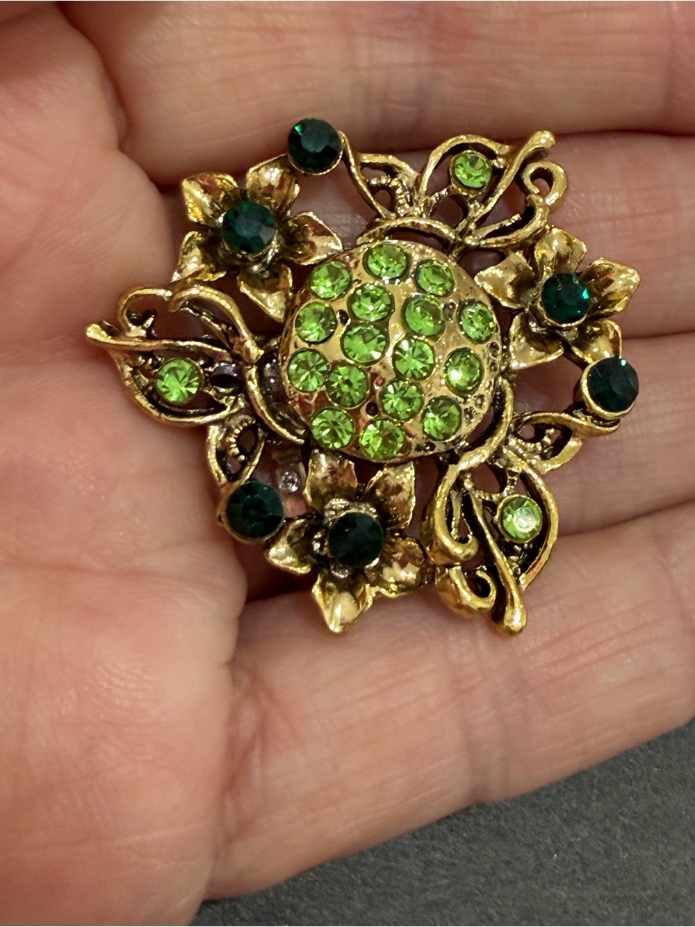 Gold-Tone Floral Brooch with Green Crystal Accents. Fluorescent green